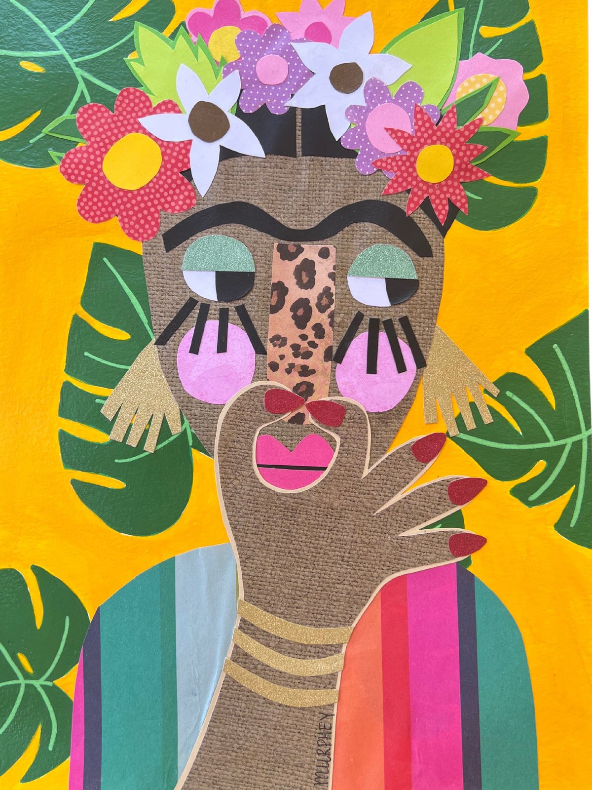 A colorful mixed-media collage portrait of a woman with a flower crown and tropical leaves on a bright yellow background.